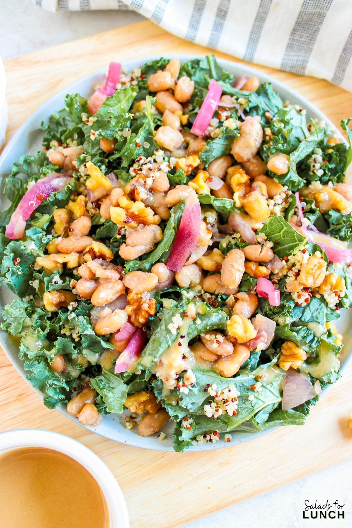 Butterbean and Walnut Kale Salad with Maple Tahini Dressing Recipe 10 - A warm and hearty vegan and gluten-free kale salad featuring quinoa, sautéed butter beans, shallots, and walnuts, all topped with a luscious maple tahini dressing.