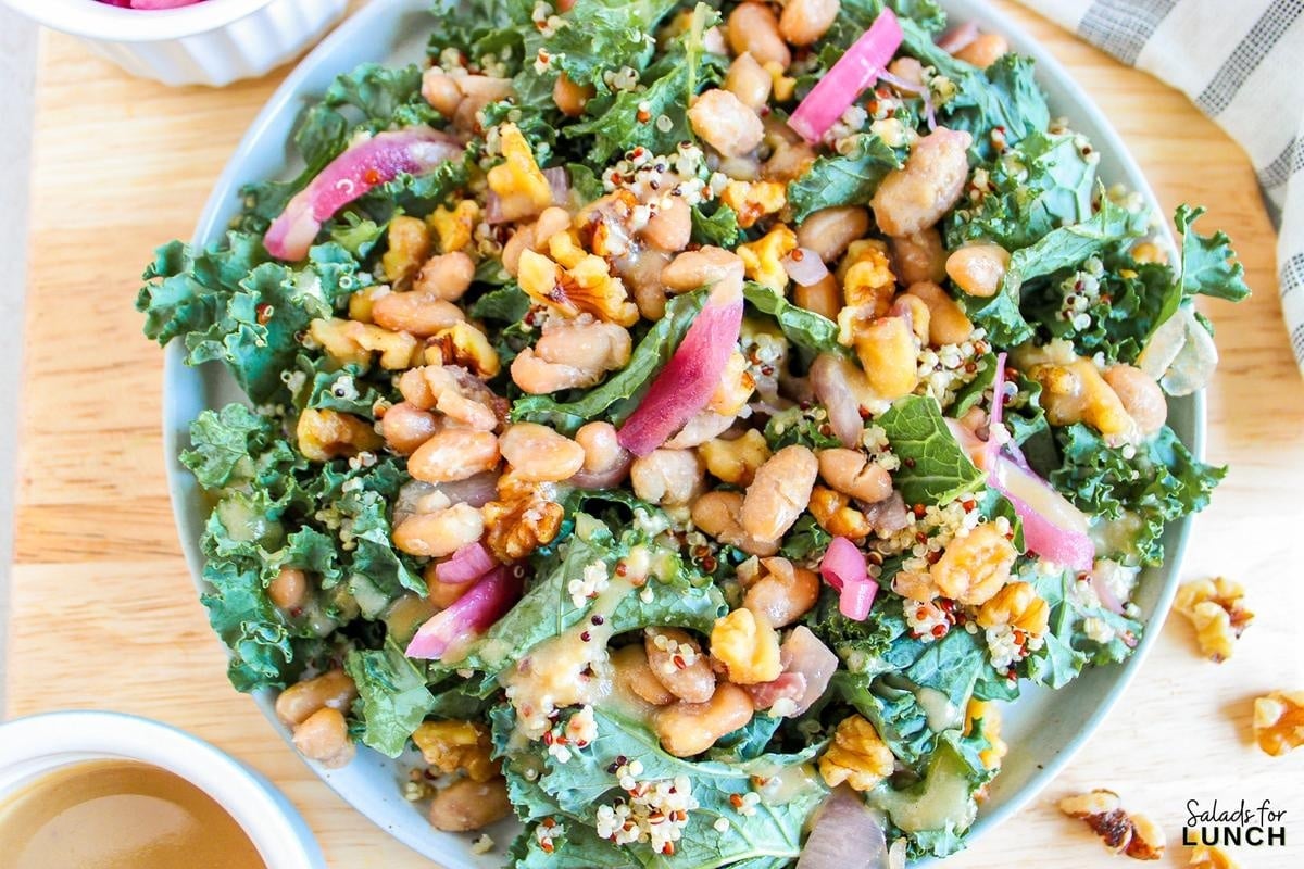 Butterbean and Walnut Kale Salad with Maple Tahini Dressing Recipe 9 - A warm and hearty vegan and gluten-free kale salad featuring quinoa, sautéed butter beans, shallots, and walnuts, all topped with a luscious maple tahini dressing.