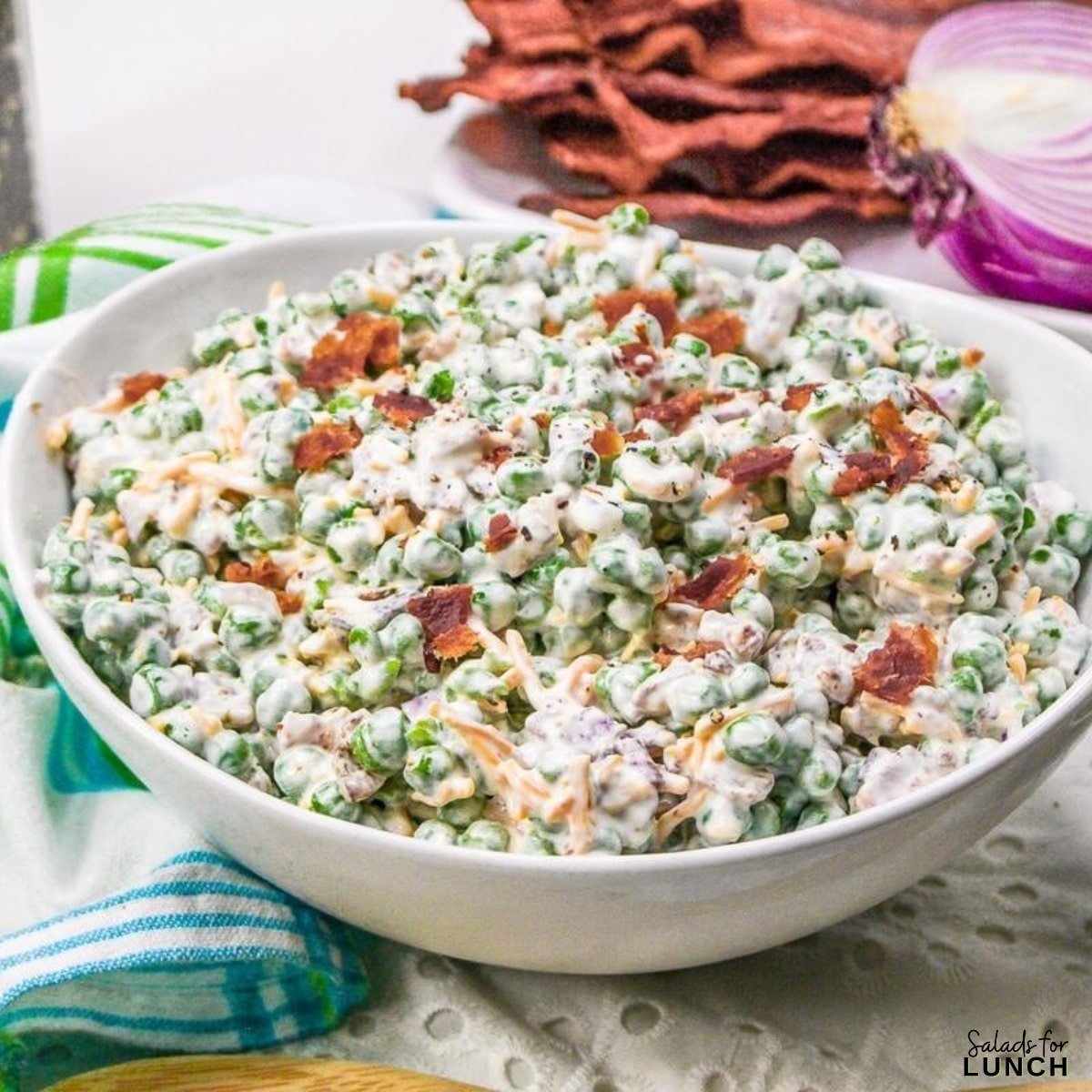 Creamy Green Pea Salad with bacon onion and cheese - We’ve rounded up 26 of the best spring salads to help you make the most of April’s freshest fruits and veggies. Whether you’re craving something light and refreshing or hearty and satisfying, there’s a salad here for every taste.